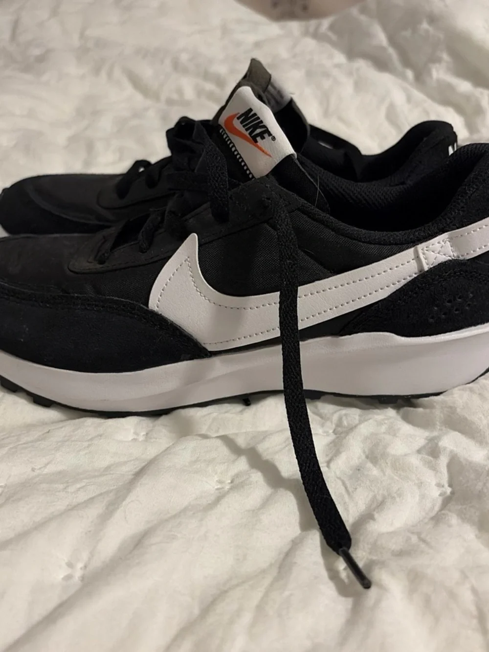 Nike Black Sneakers with White Swoosh and Orange Logo